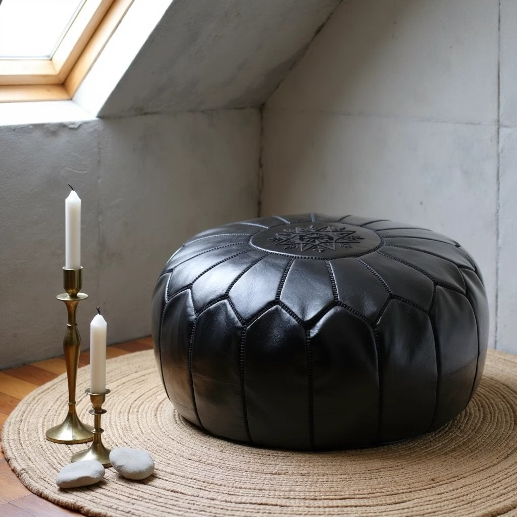 Black Moroccan leather pouf photographed from a low angle