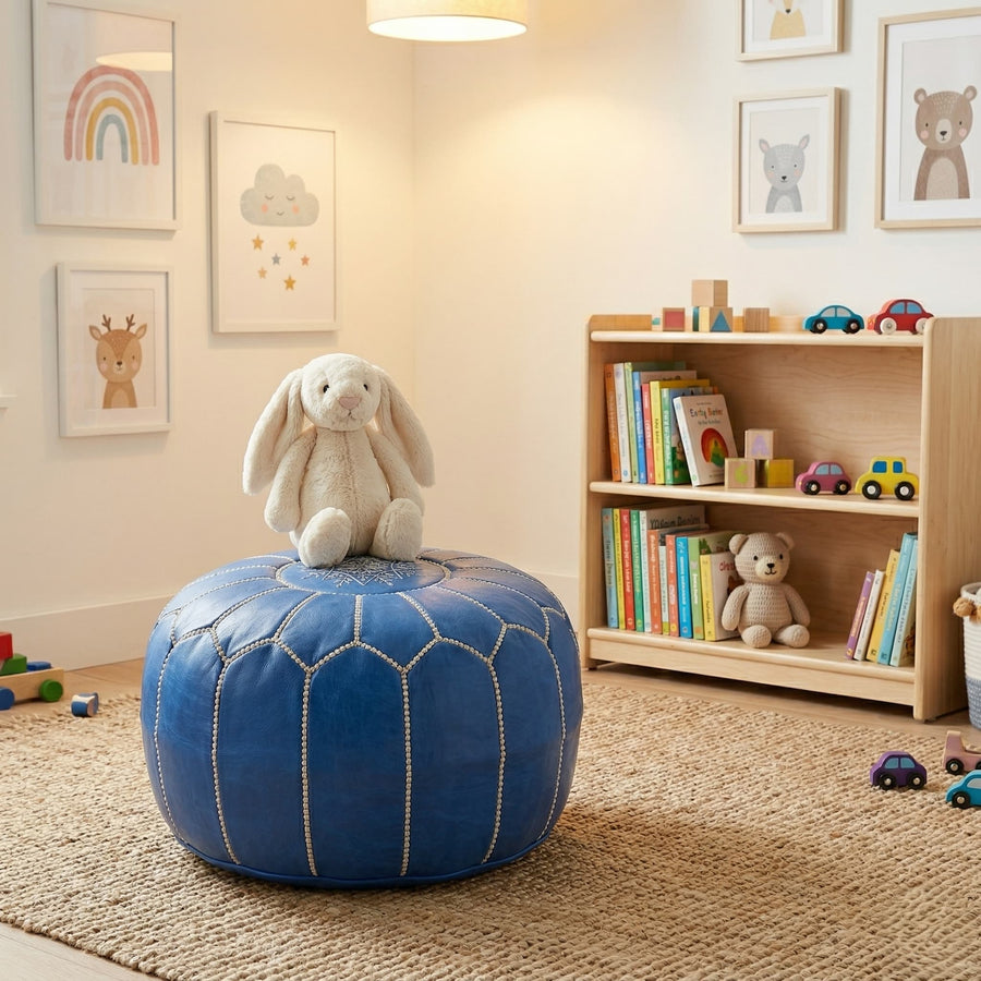 Denim blue leather pouf in a children's nursery with a soft toy resting on top