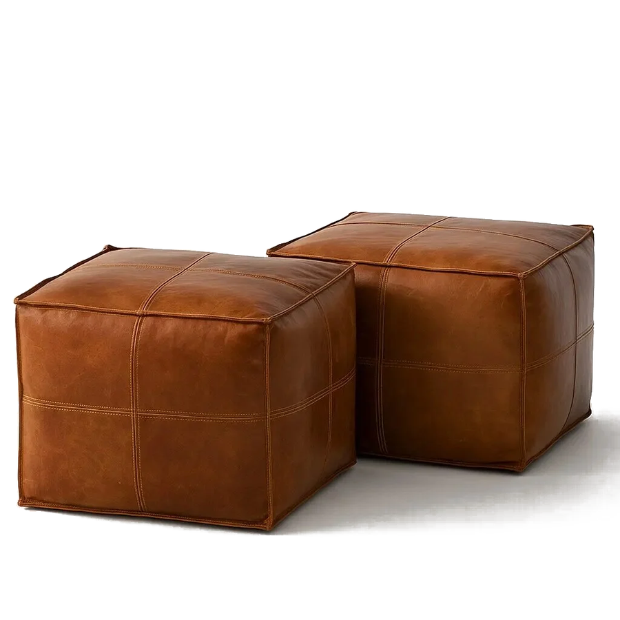Two brown square leather ottomans, handmade Moroccan cross-stitch poufs in full-grain goatskin, on a white background