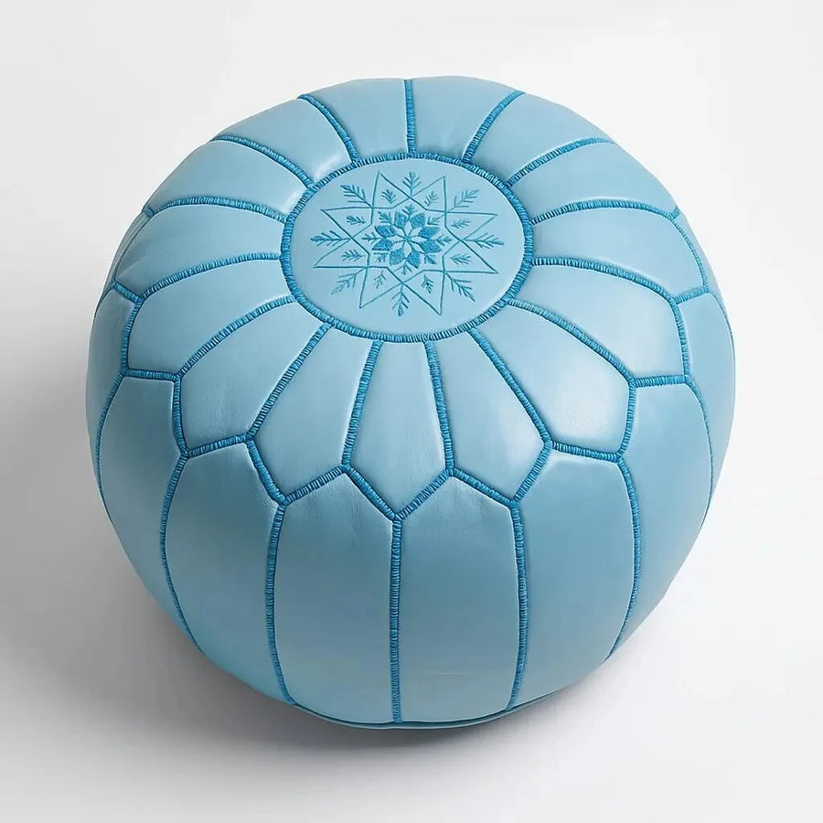 Sky blue Moroccan round leather pouf with hand-embroidered eight-pointed star on the top panel, on a plain white background