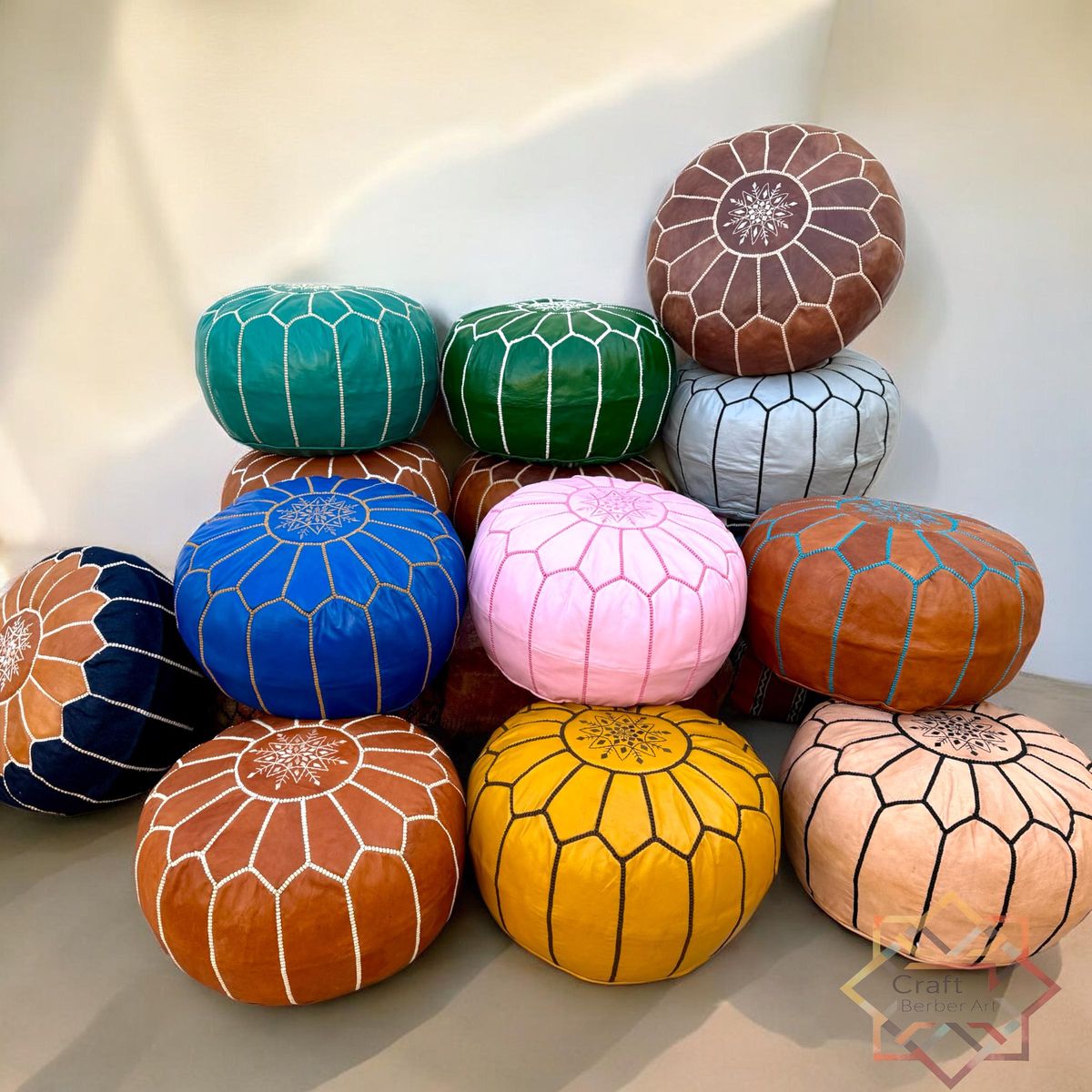 Handmade Moroccan round leather pouf in natural tan with hand-embroidered star
