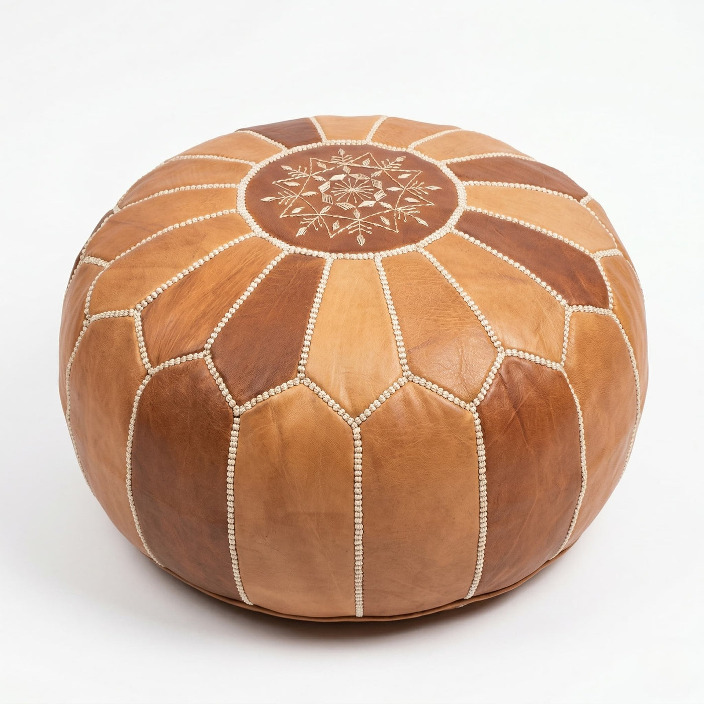 Natural tan Moroccan round leather pouf with hand-embroidered eight-pointed star, on a plain white background
