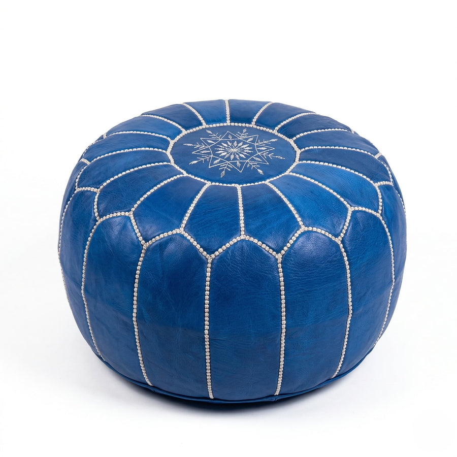 Denim blue Moroccan leather pouf, 21 inch round ottoman with hand-embroidered off-white star motif, on a white background