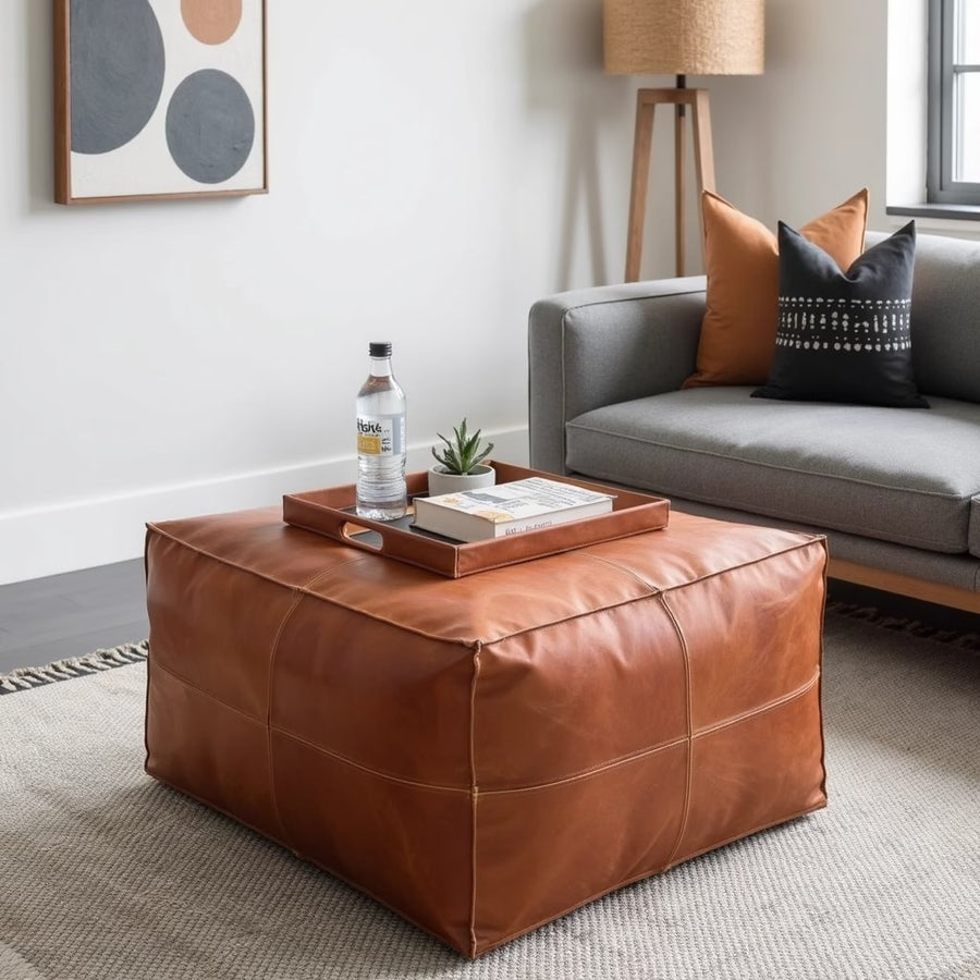 Dark brown square leather ottoman in a nursery with soft toys and a rug