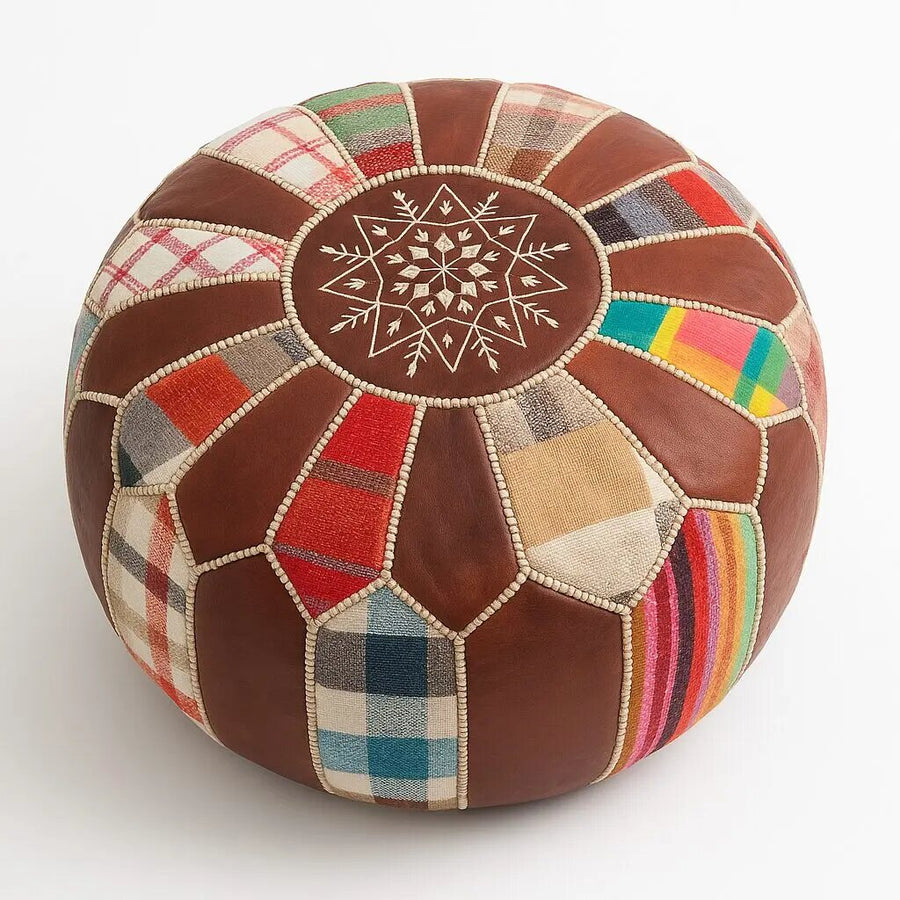 Multicolor patchwork Moroccan leather round pouf with hand-embroidered star mandala on the top panel, on a plain white background