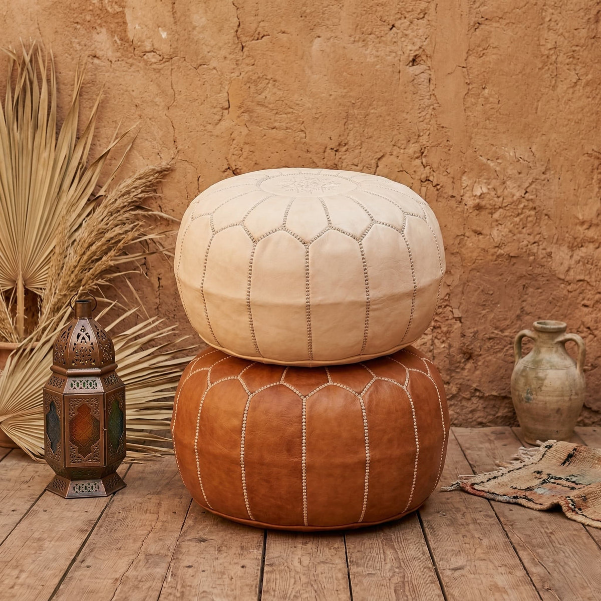 Undyed leather pouf used as a footrest in a neutral interior