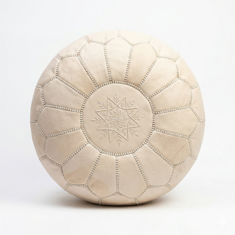Top view of the undyed leather pouf showing the tonal star medallion embroidery