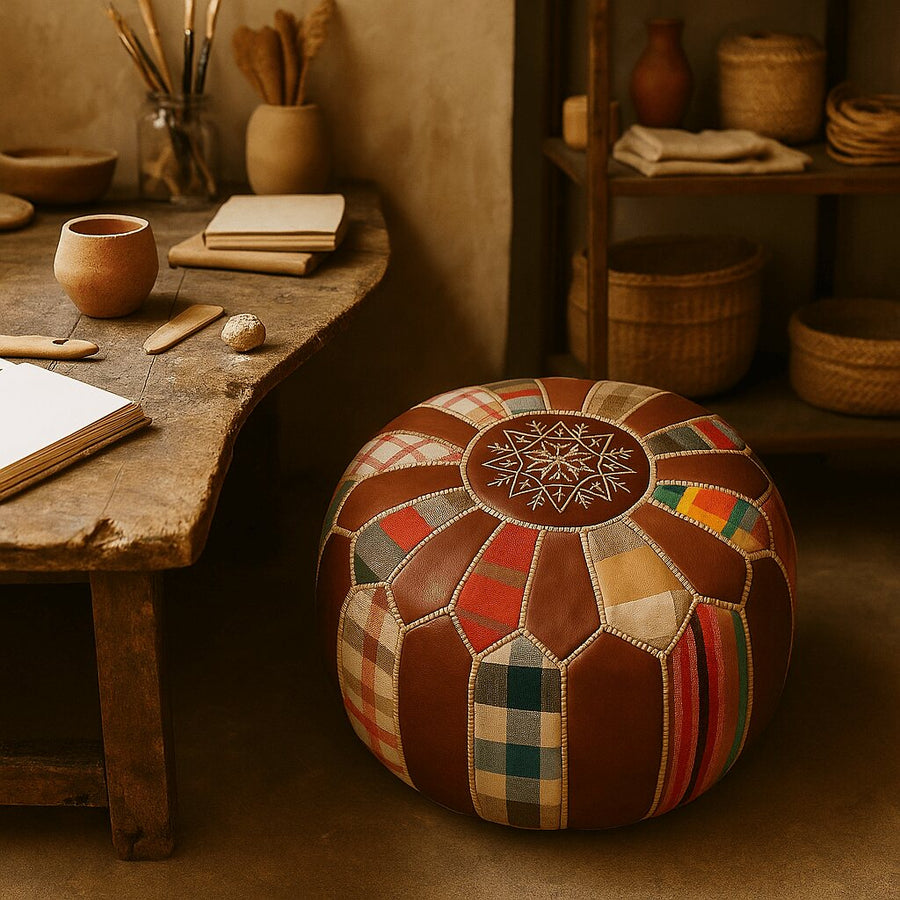 Multicolor patchwork leather pouf in a rustic artisan studio surrounded by hand tools and pottery
