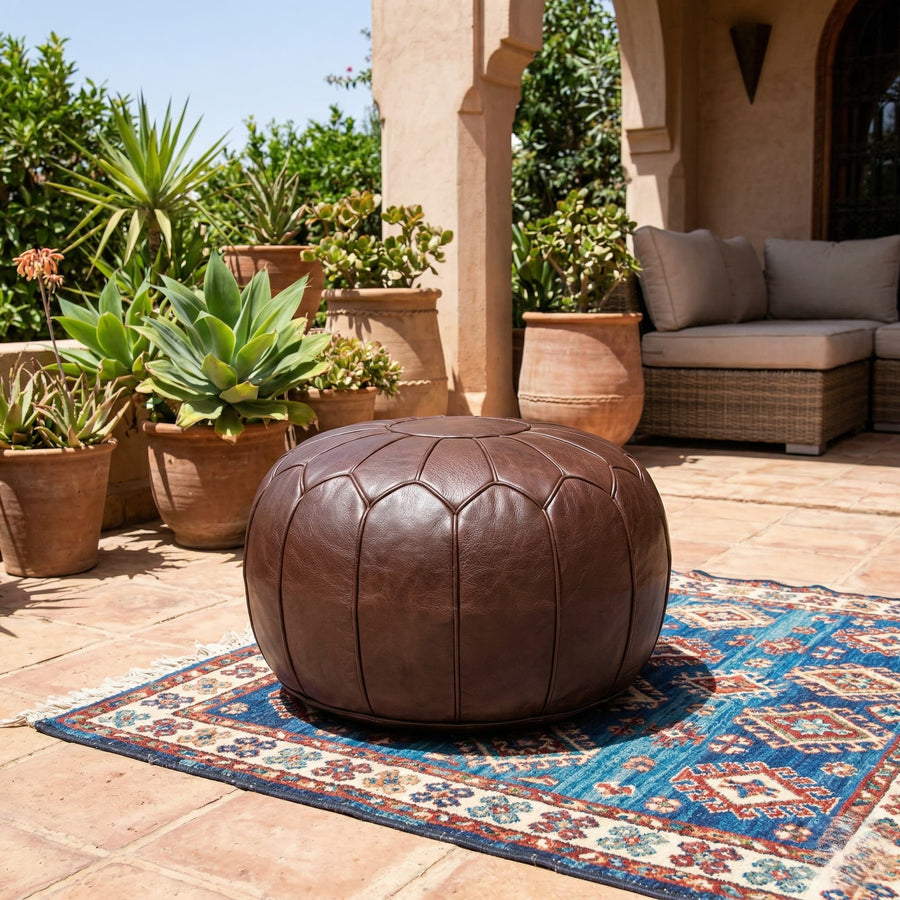 Chocolate brown leather floor pouf in a styled living room
