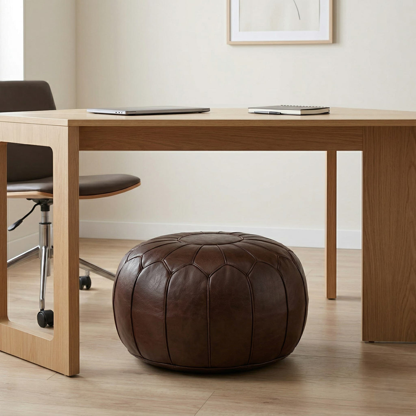 Dark brown Moroccan leather pouf used as a low seat