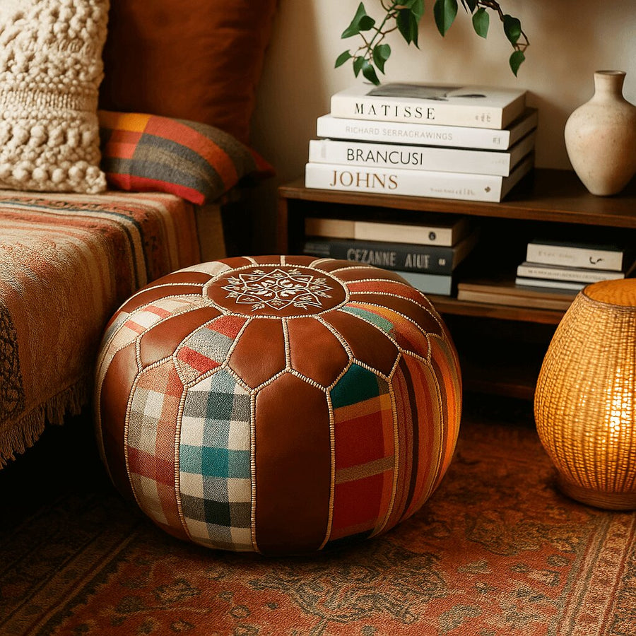 Colorful patchwork pouf in a cozy reading nook with stacked books, a floor lamp and patterned cushions