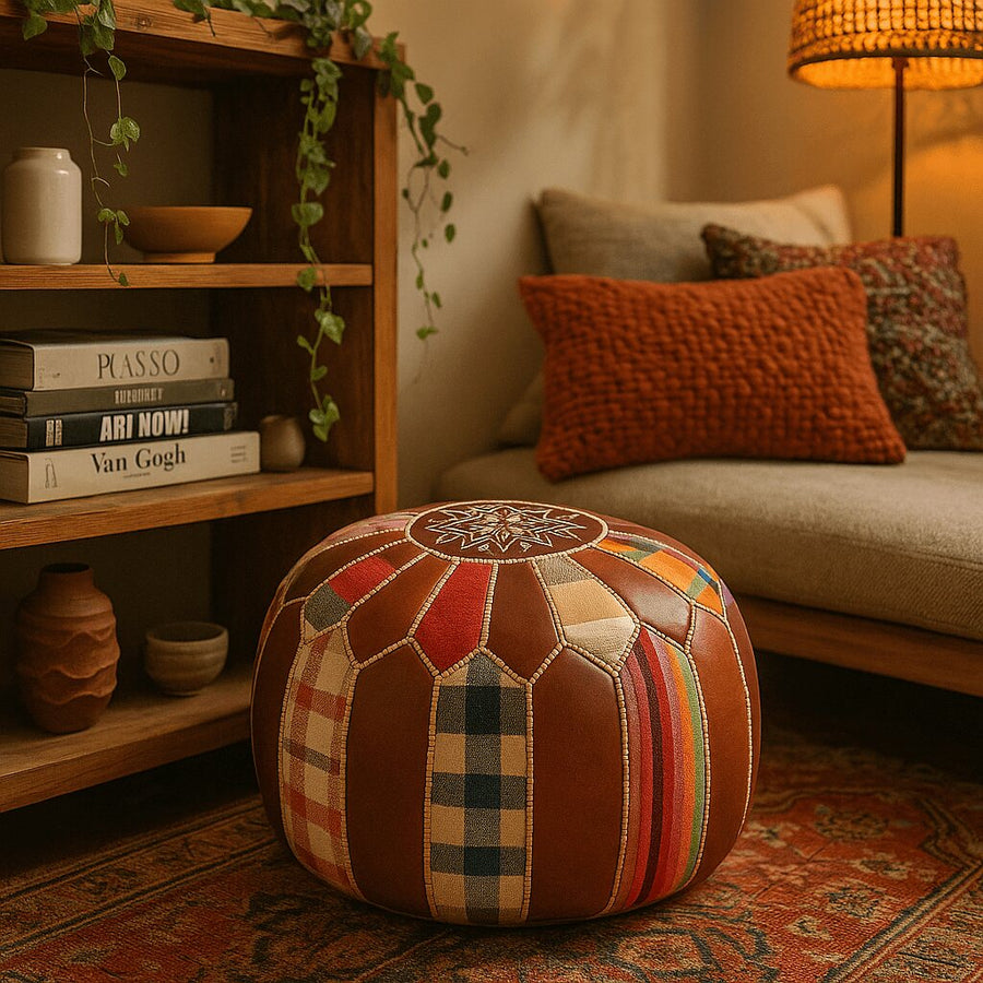 Patchwork Moroccan pouf in a warm-toned boho corner with layered textiles and a woven lamp