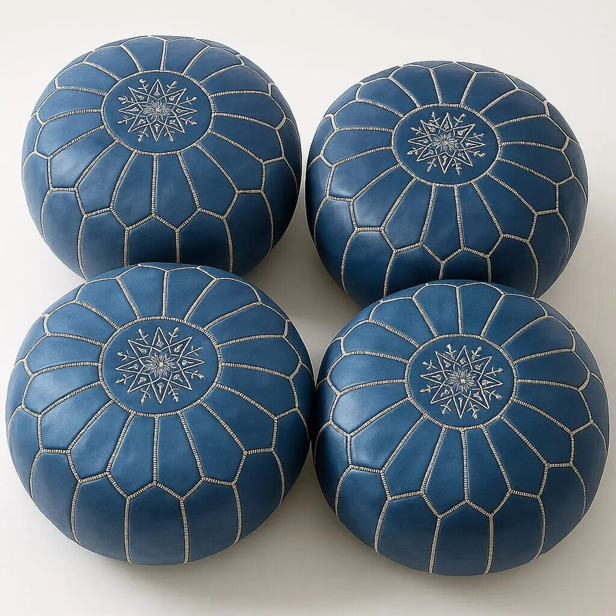 Four matching cobalt blue Moroccan leather poufs with contrasting white seam stitching